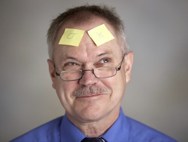 Man with post it notes on forehead