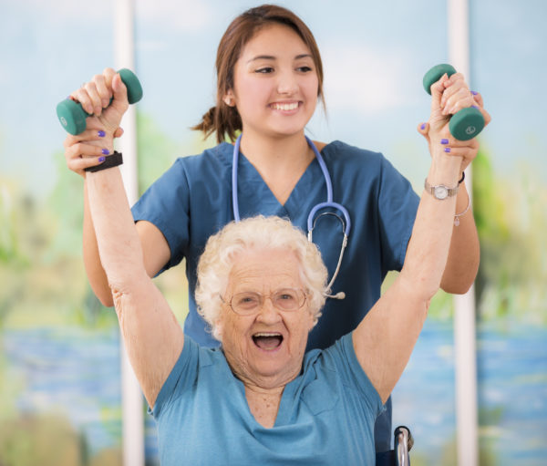 Physical therapist helps strengthen senior woman