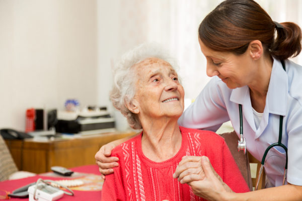 caregiver with elderly woman in nursing home