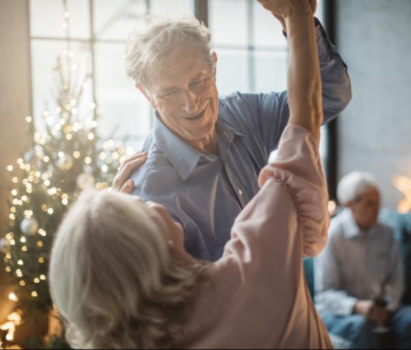 senior couple dancing in assisted living community at Christmastime